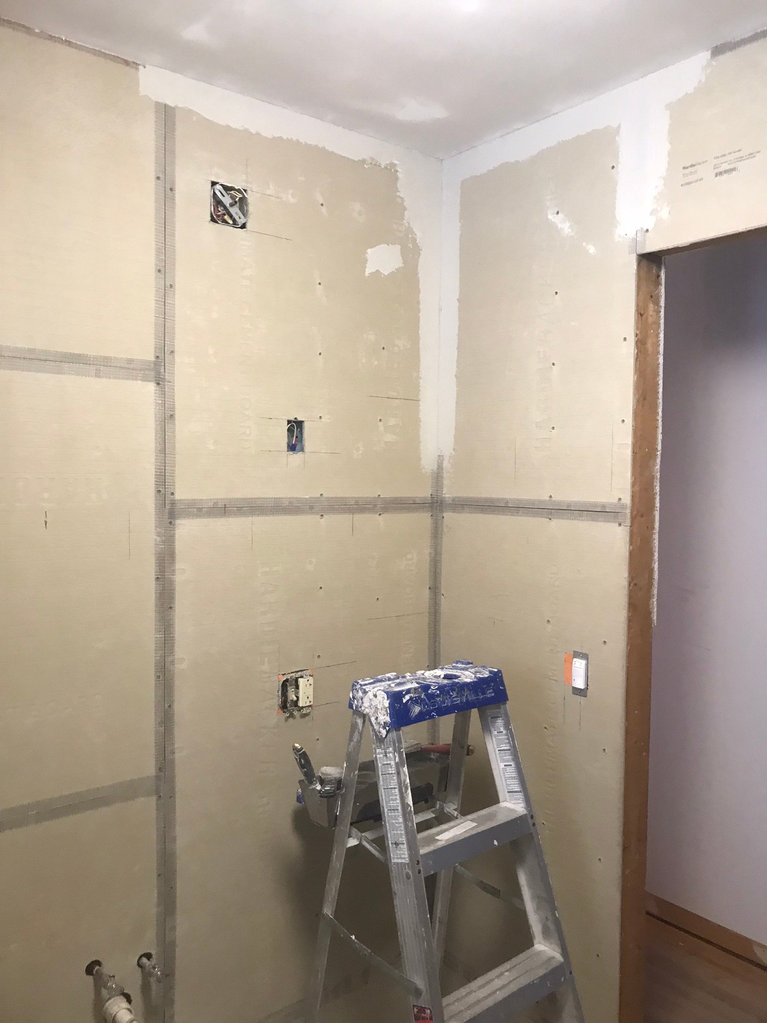 Bathroom walls rebuilt with cement backer board and taped seams before tile inspection