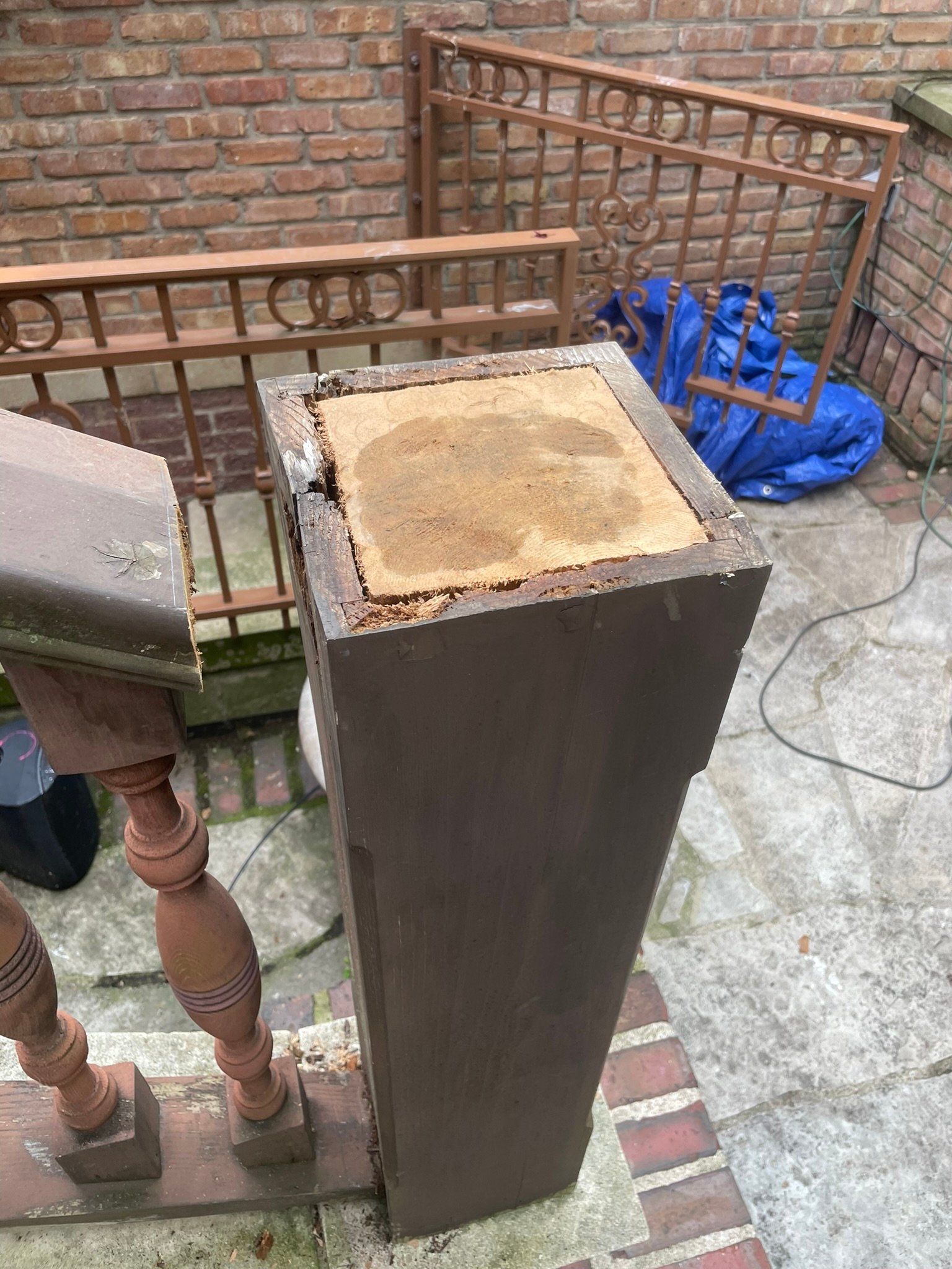 Rotted railing newel post opened up and repaired with a new solid wood insert