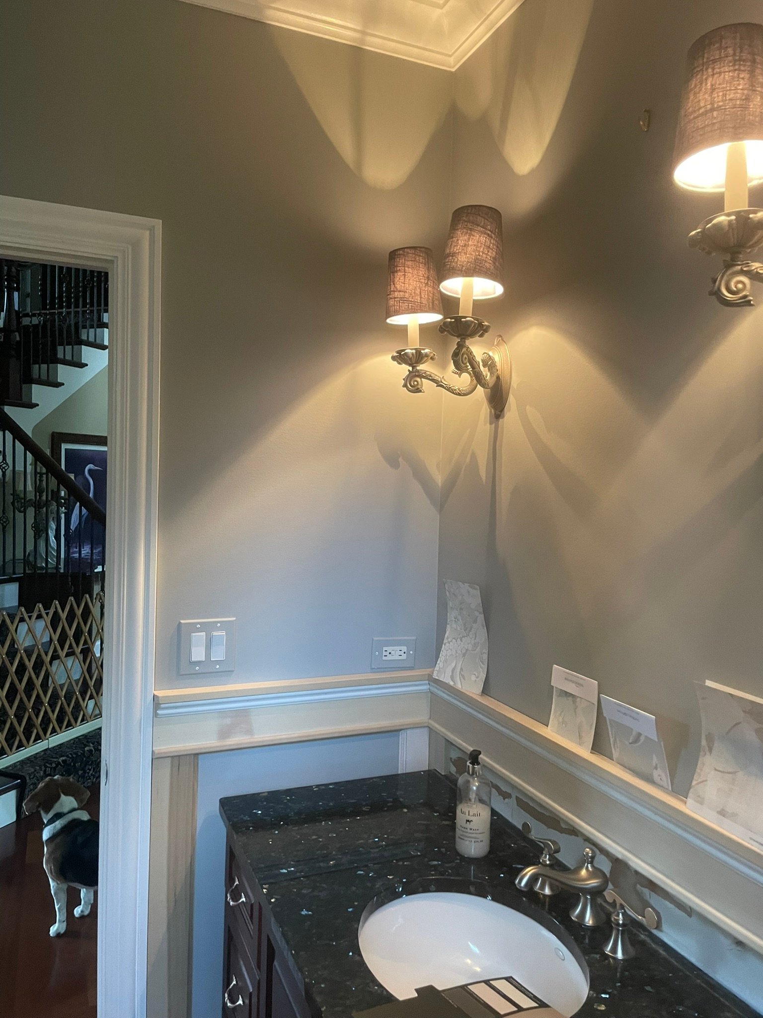Powder room refresh with new sconces, wallpaper and black granite vanity top
