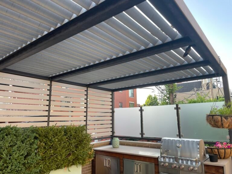 Louvered pergola and outdoor kitchen with built-in grill on a rooftop deck in Lake County IL