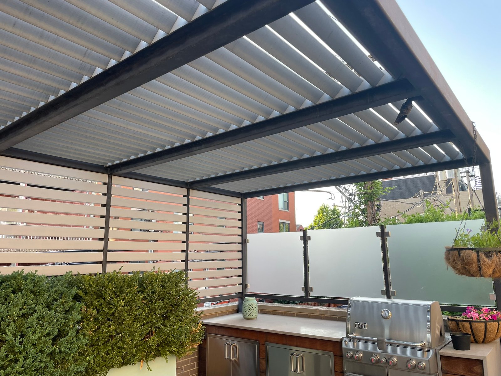 Louvered pergola and outdoor kitchen with built-in grill on a rooftop deck in Lake County IL
